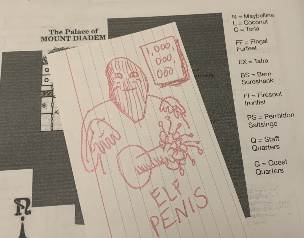 The map of a strange dwarven castle from a vintage D&D adventure and on top is an index card with a bizarre drawing of an elf penis. 